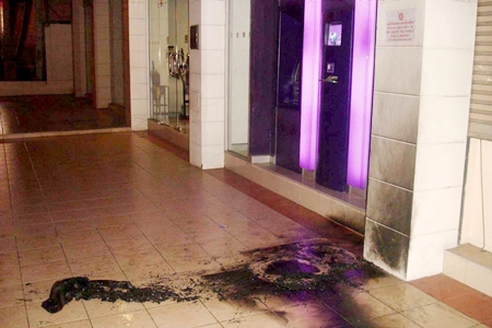 Scorch marks are seen on the pavement outside the Siam Commercial Bank on Central Road.